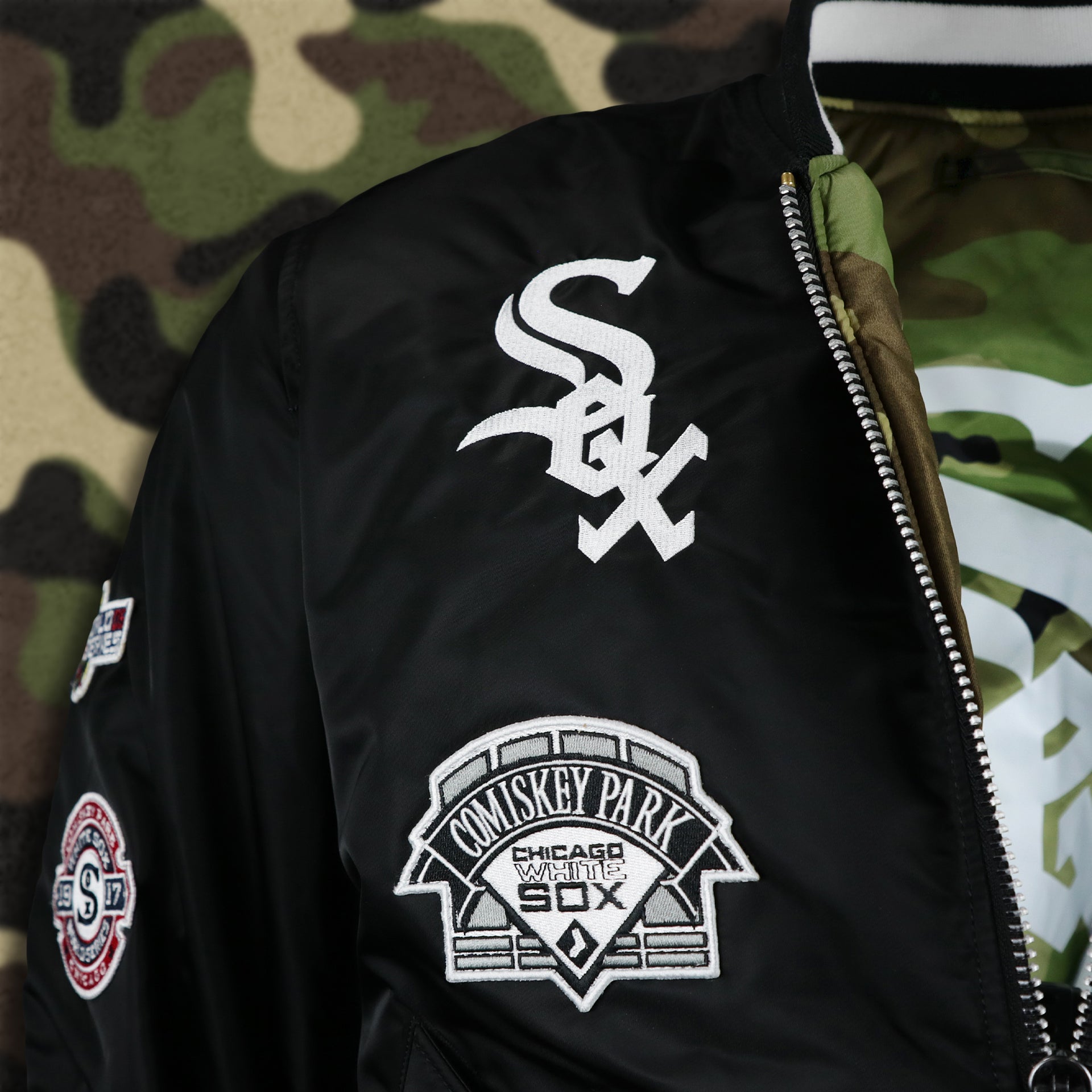 The White Sox Logo on the Comiskey Park Side Patch on the Chicago White Sox MLB Patch Alpha Industries Reversible Bomber Jacket With Camo Liner | Black Bomber Jacket