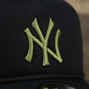 The Yankees Logo on the New York Yankees Alpha Industries Flying A Mesh Print 9Forty Trucker Hat With Flight Tag | Black Trucker Hat