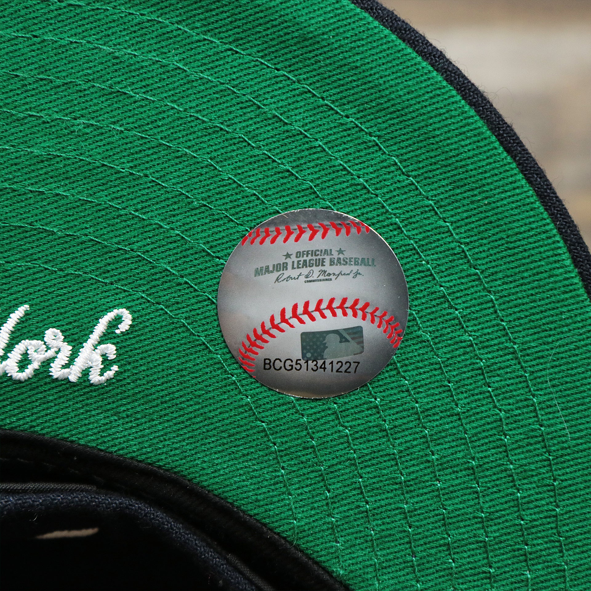 The MLB Baseball Sticker on the New York Wordmark Side Split New York Yankees Vintage Green Bottom Embroidered Undervisor Fitted Cap | Navy Blue 59Fifty Cap