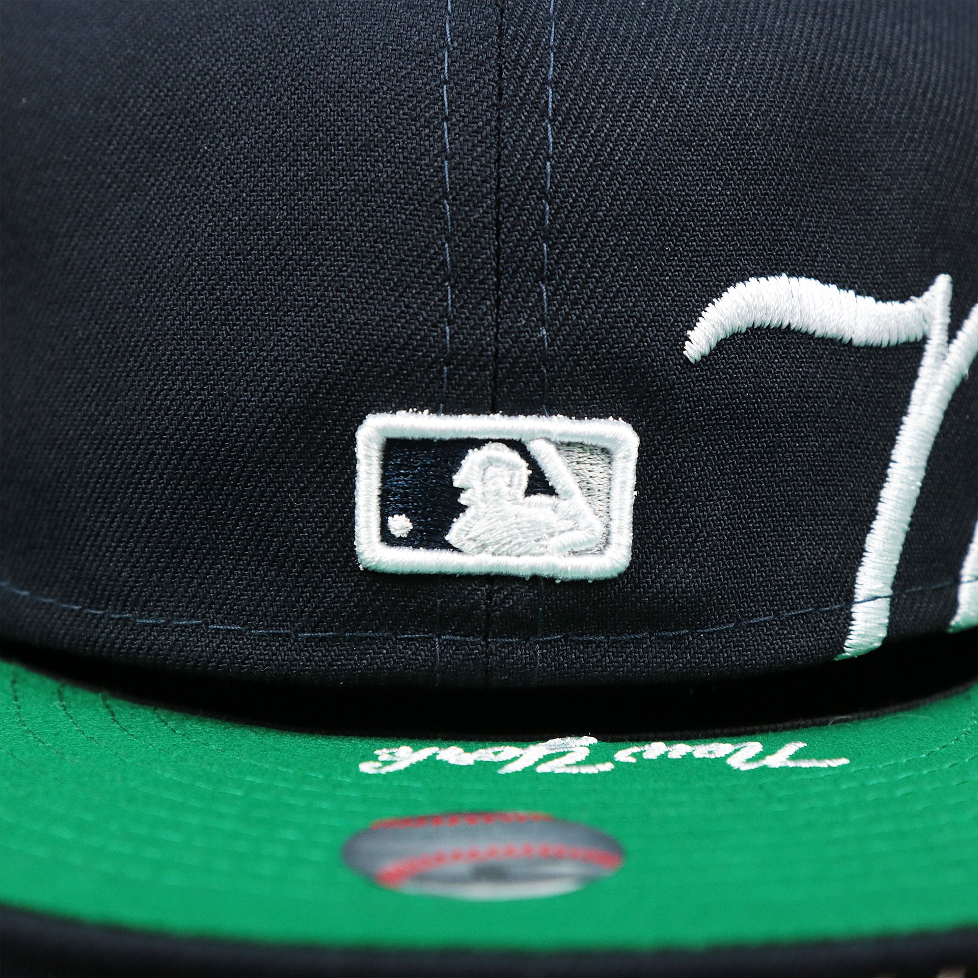 The MLB Batterman Logo on the New York Wordmark Side Split New York Yankees Vintage Green Bottom Embroidered Undervisor Fitted Cap | Navy Blue 59Fifty Cap
