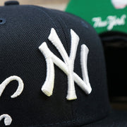 The Yankees Logo on the New York Wordmark Side Split New York Yankees Vintage Green Bottom Embroidered Undervisor Fitted Cap | Navy Blue 59Fifty Cap