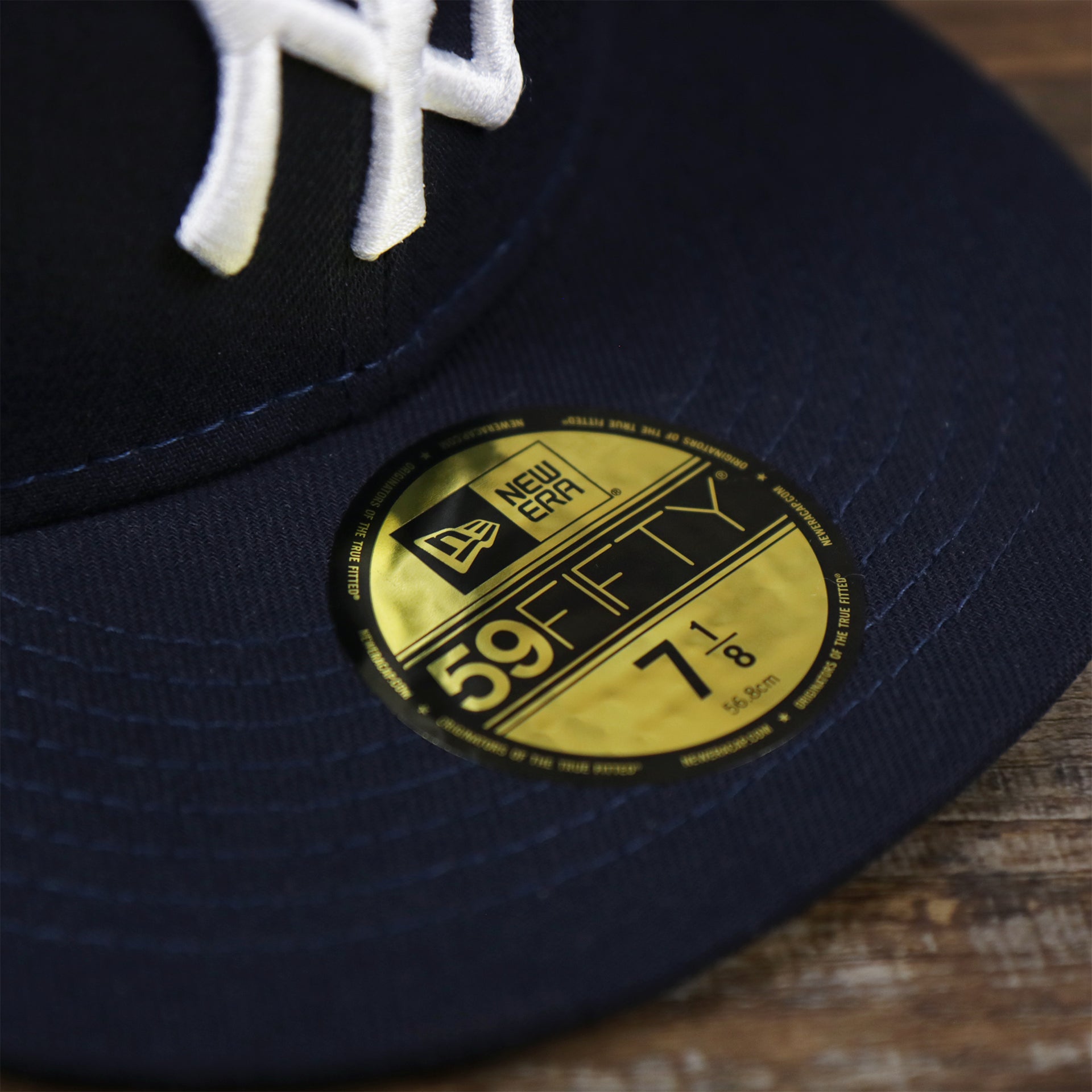 The 59Fifty Sticker on the New York Yankees Alpha Industries Side Patch Army Green Undervisor 59FIfty Fitted Cap With Hangtag | Navy Blue 59FIfty Cap