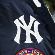 The Yankees Logo on the New York Yankees MLB Patch Alpha Industries Reversible Bomber Jacket With Camo Liner | Navy Blue Bomber Jacket