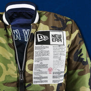 A close up of the New Era Sports Unite Us Graphic on the New York Yankees MLB Patch Alpha Industries Reversible Bomber Jacket With Camo Liner | Navy Blue Bomber Jacket