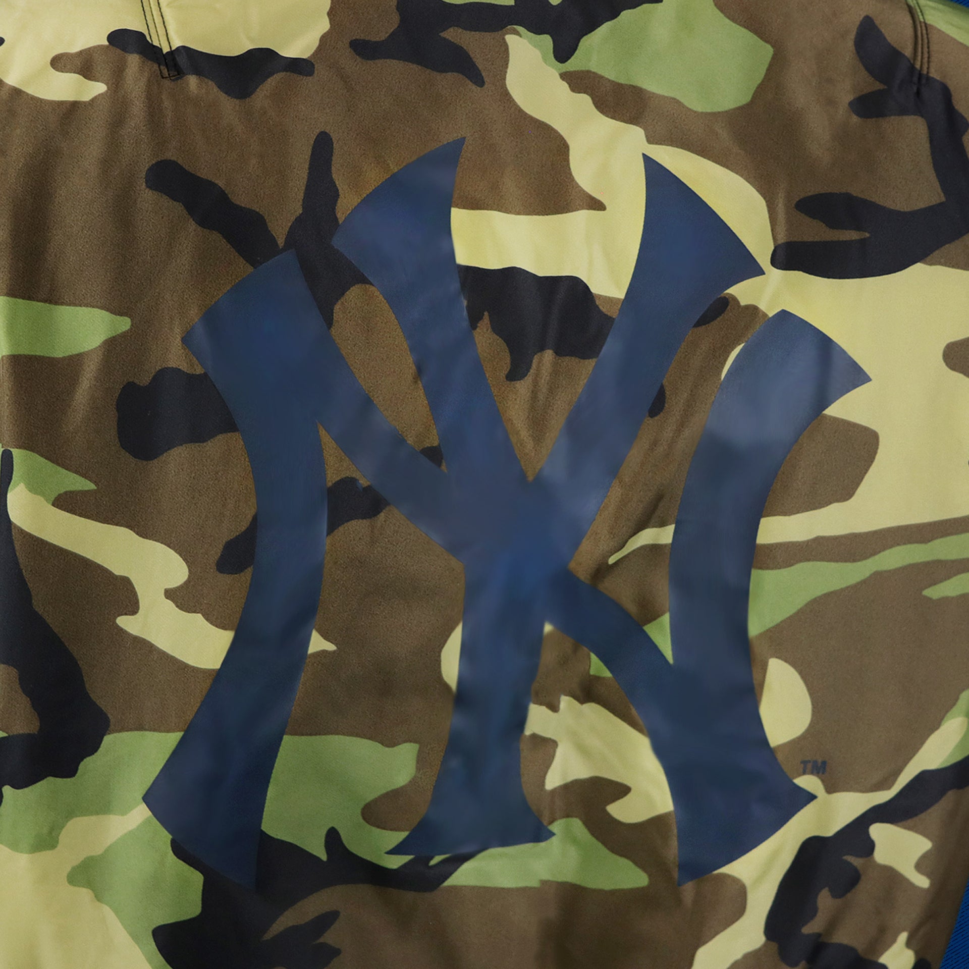 The New York Yankees Logo on the New York Yankees MLB Patch Alpha Industries Reversible Bomber Jacket With Camo Liner | Navy Blue Bomber Jacket