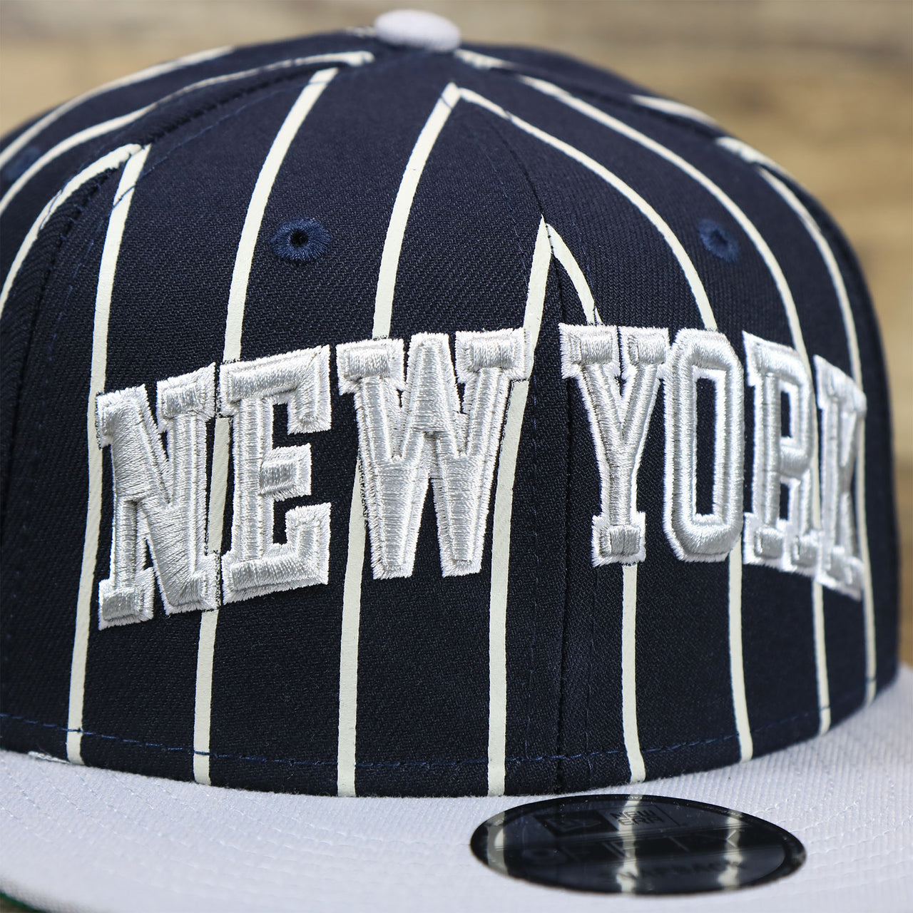 The New York Wordmark on the New York Yankees City Arch Striped 9Fifty Snapback Cap | Pin Stripe 9Fifty Cap