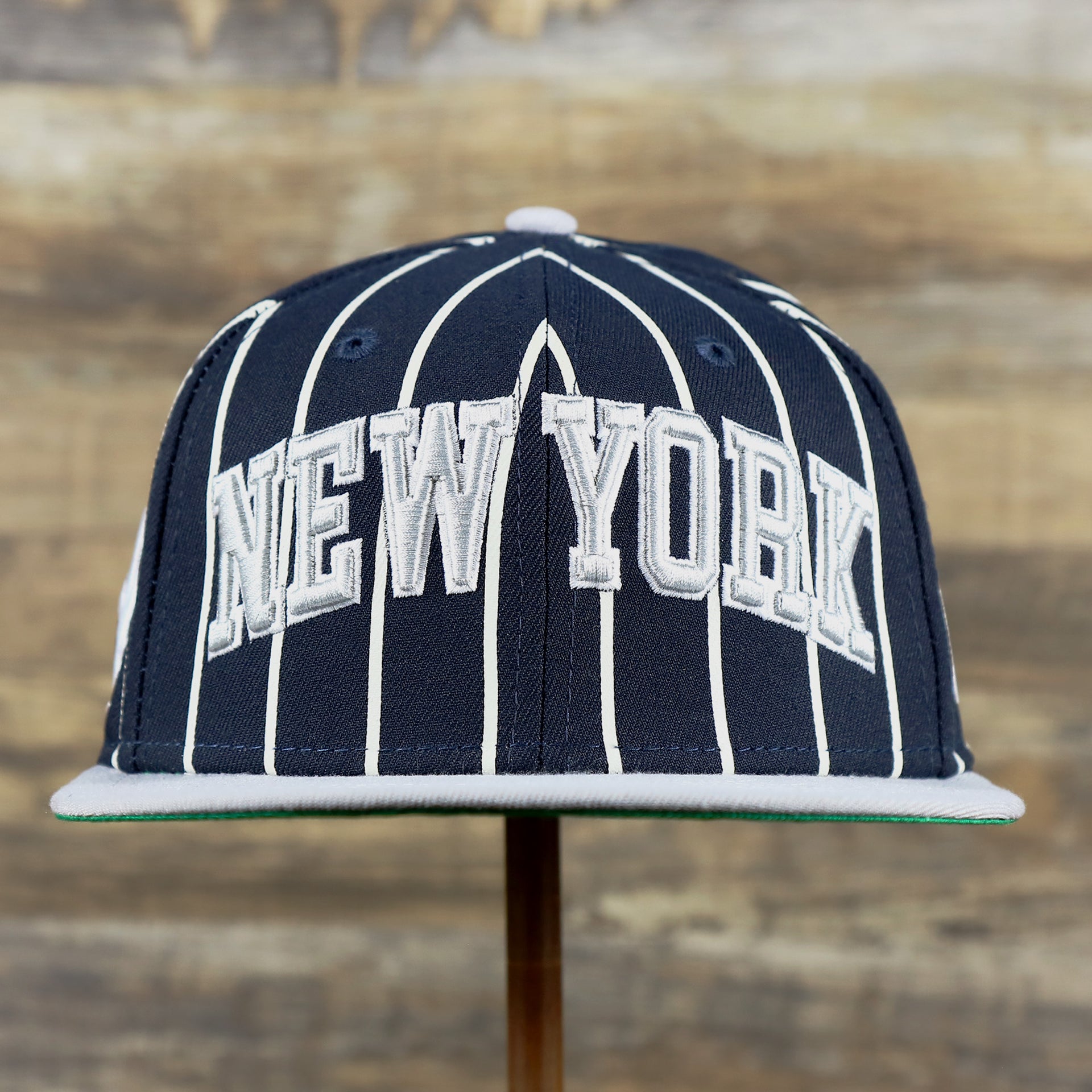 The front of the New York Yankees City Arch Striped 9Fifty Snapback Cap | Pin Stripe 9Fifty Cap