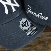 The 47 Brand Sticker on the Cooperstown New York Yankees Green Bottom Yankees Wordmark Fitted Cap | Vintage Navy Fitted Cap