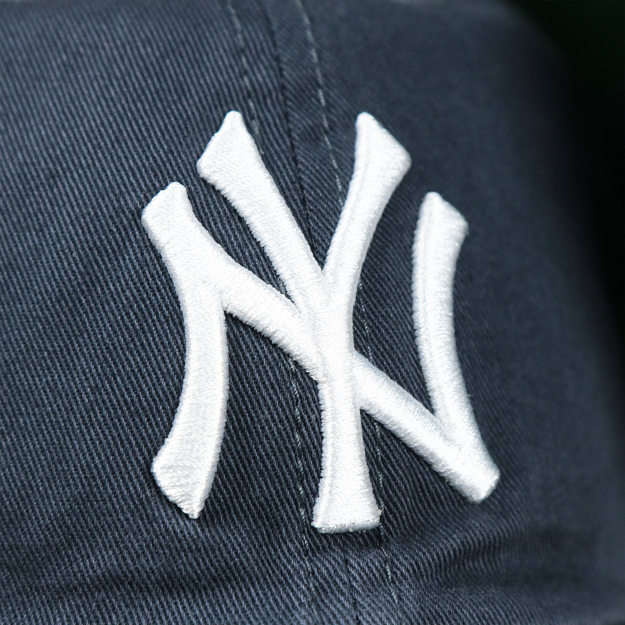 The Yankees Logo on the Cooperstown New York Yankees Green Bottom Yankees Wordmark Fitted Cap | Vintage Navy Fitted Cap