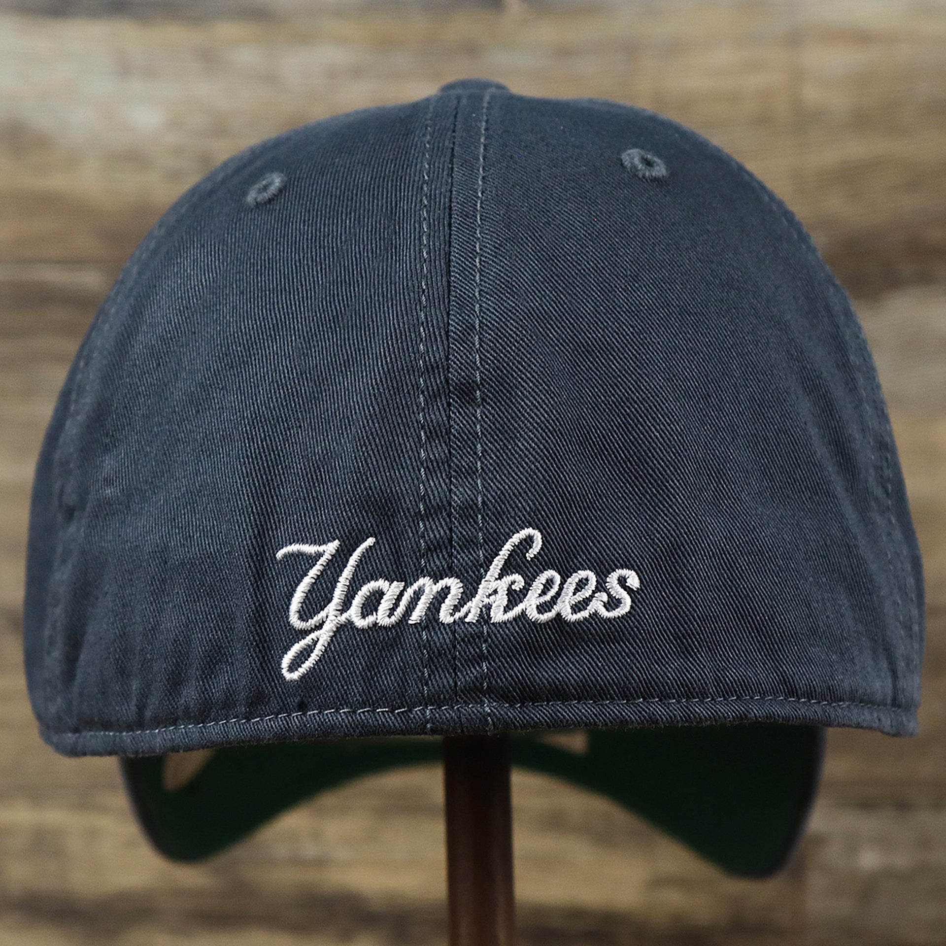 The backside of the Cooperstown New York Yankees Green Bottom Yankees Wordmark Fitted Cap | Vintage Navy Fitted Cap