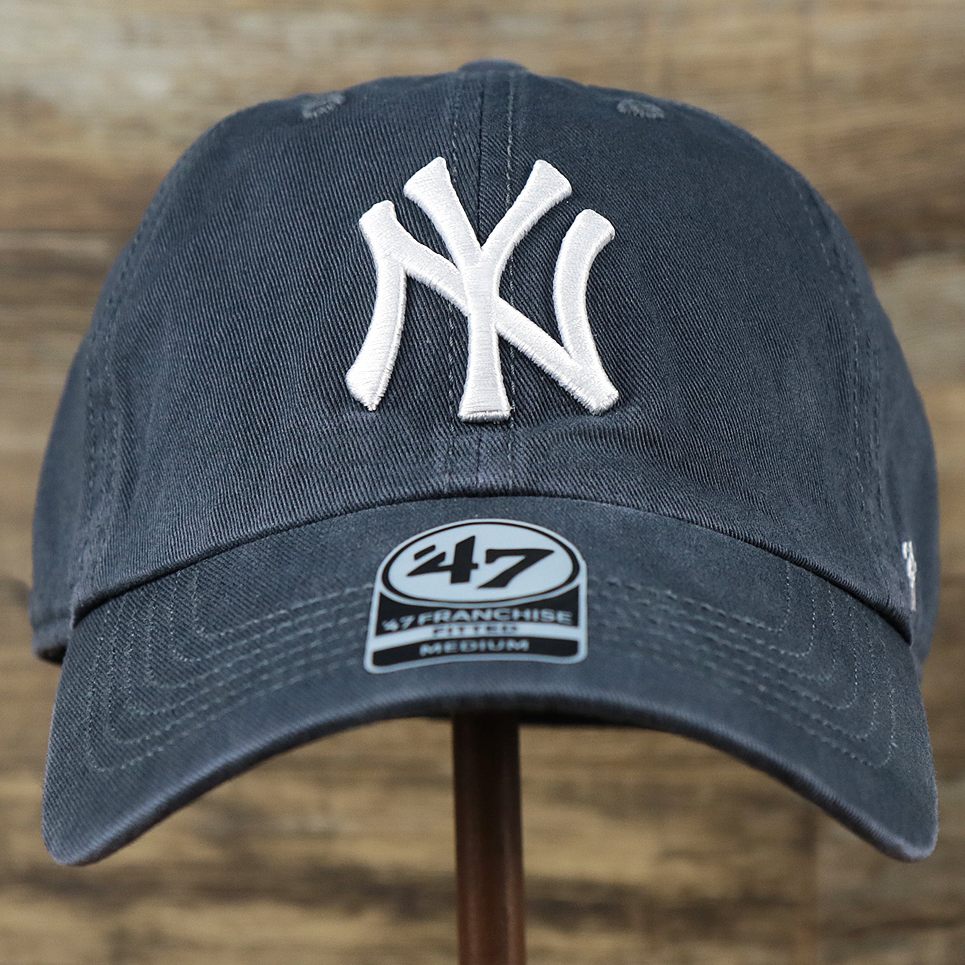 The front of the Cooperstown New York Yankees Green Bottom Yankees Wordmark Fitted Cap | Vintage Navy Fitted Cap