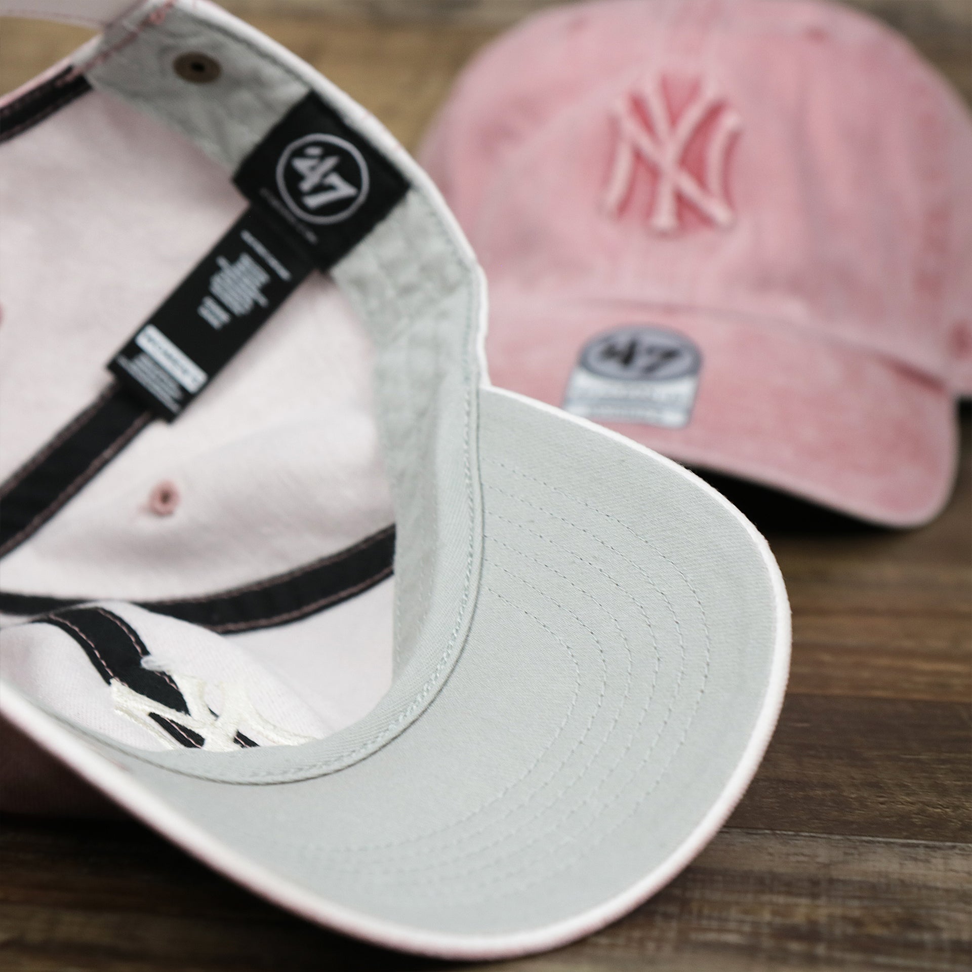 The undervisor on the Women’s New York Yankees Gray Bottom Vintage Washed Dad Hat | Vintage Pink Women’s Dad Hat