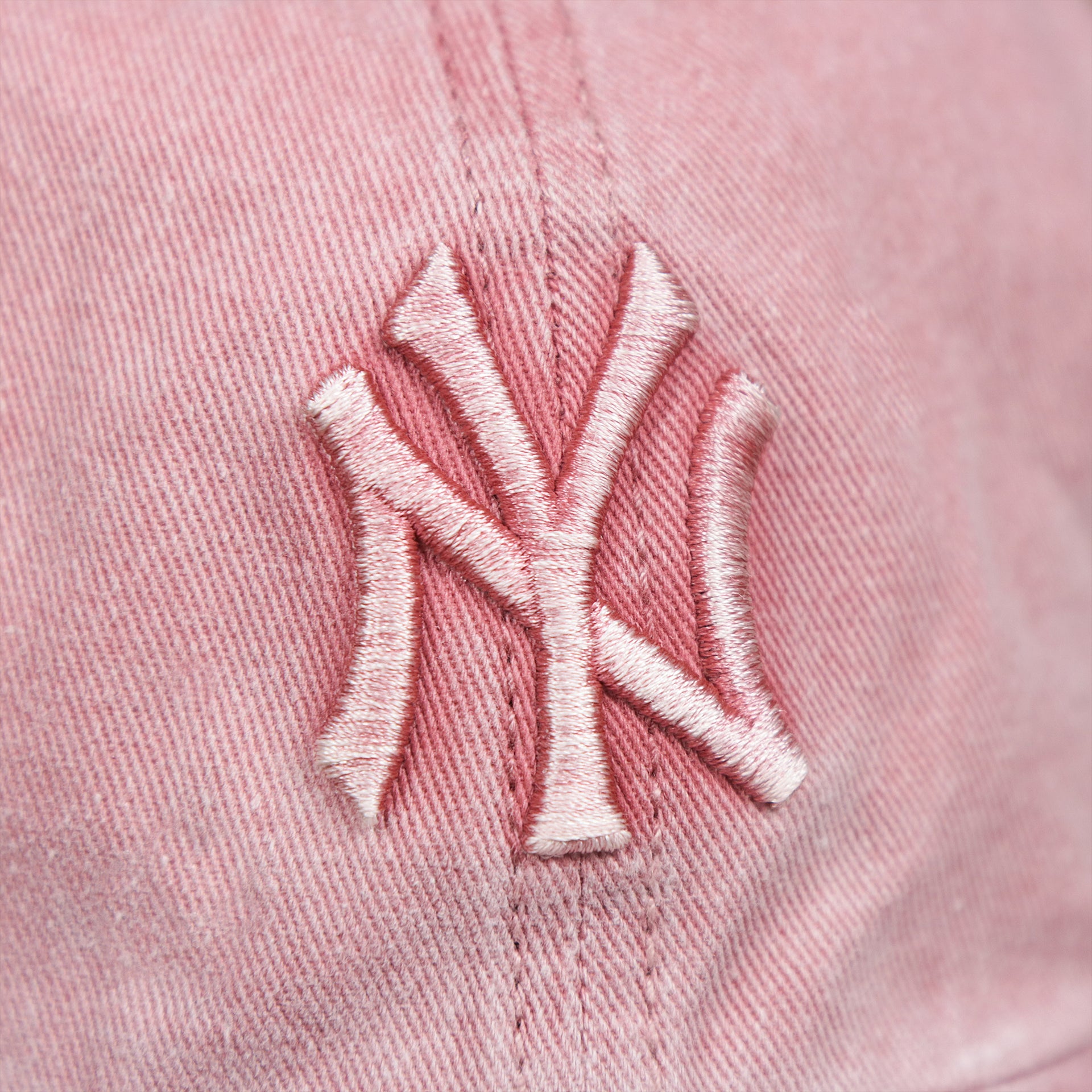 The Yankees Logo on the Women’s New York Yankees Gray Bottom Vintage Washed Dad Hat | Vintage Pink Women’s Dad Hat