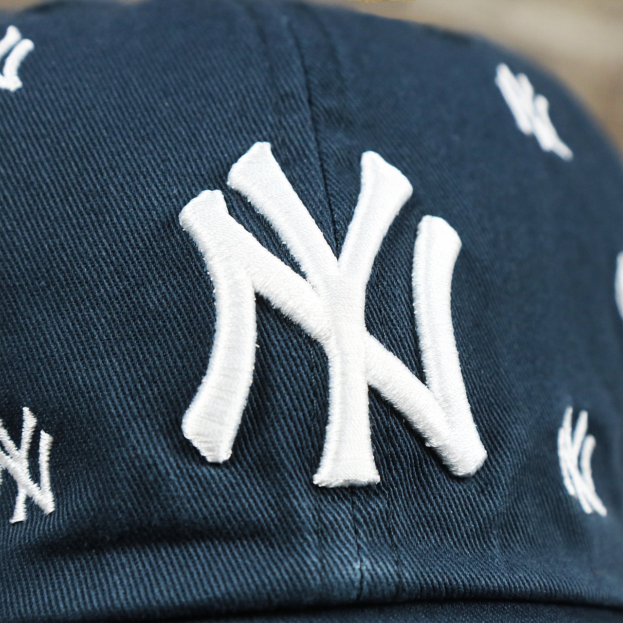 The Yankees Logo on the Women’s New York Yankees All Over Yankees Logo Dad Hat | Navy Women’s Dad Hat