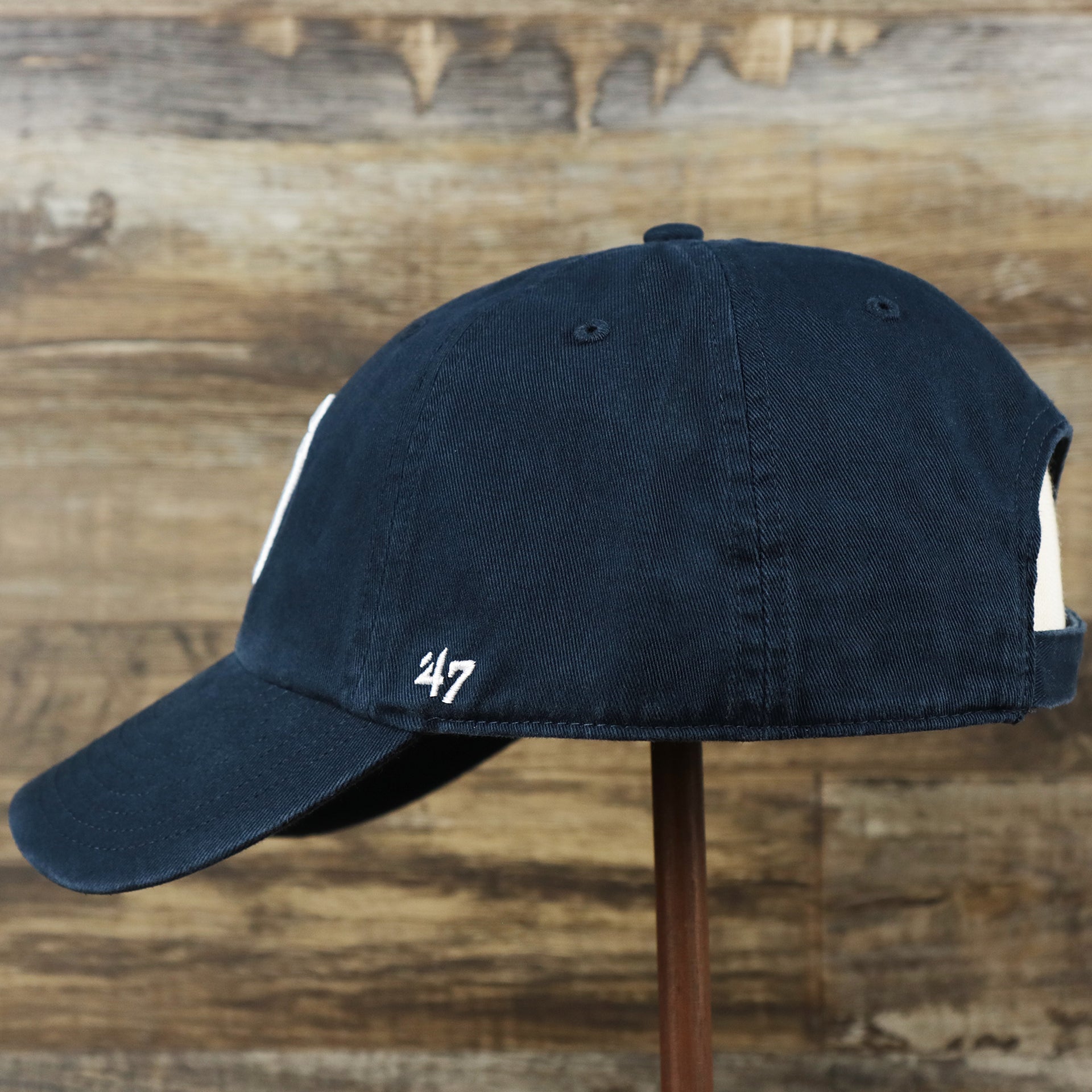 The wearer's left on the Cooperstown New York Yankees Retro Yankees Logo Dad Hat | Navy Dad Hat