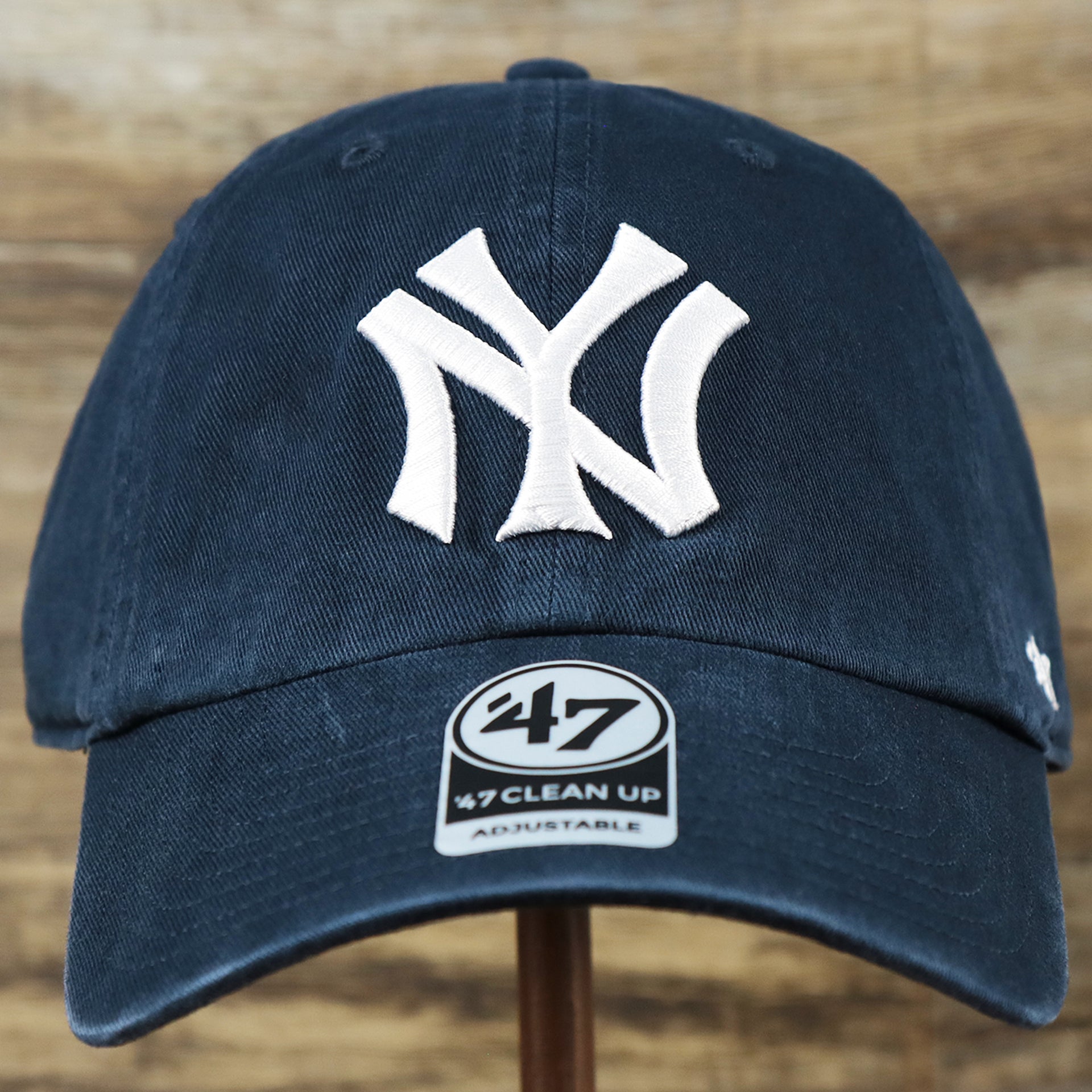 The front of the Cooperstown New York Yankees Retro Yankees Logo Dad Hat | Navy Dad Hat