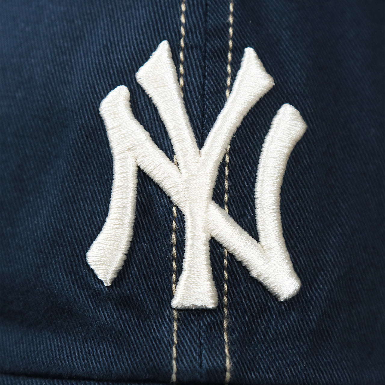 The Yankees logo on the Cooperstown New York Yankees Green Bottom Mesh Back Snapback Cap | Navy Mesh Snapback