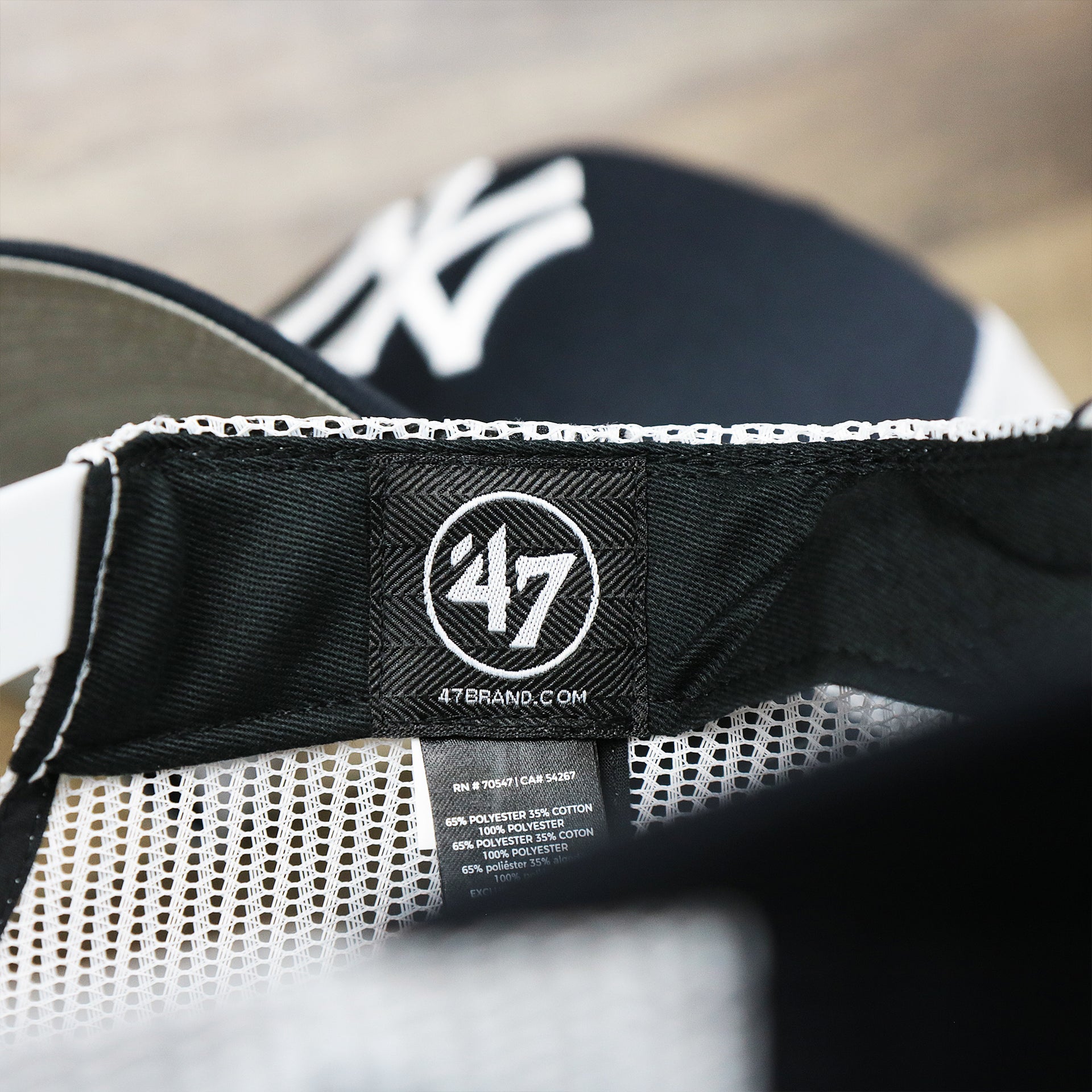 The 47 Brand Tag on the New York Yankees Mesh Back Gray Bottom Trucker Hat | Navy Blue Dad Hat