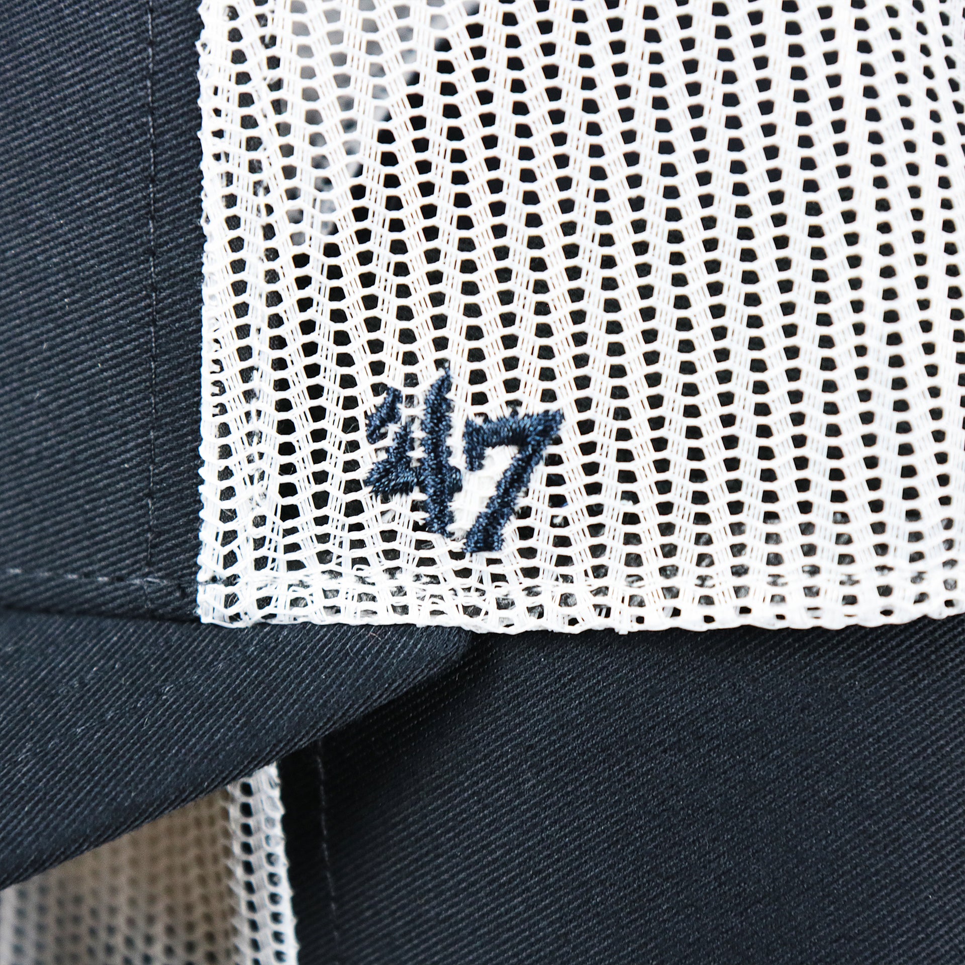 The 47 Brand Logo on the New York Yankees Mesh Back Gray Bottom Trucker Hat | Navy Blue Dad Hat