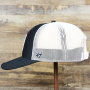 The wearer's left on the New York Yankees Mesh Back Gray Bottom Trucker Hat | Navy Blue Dad Hat