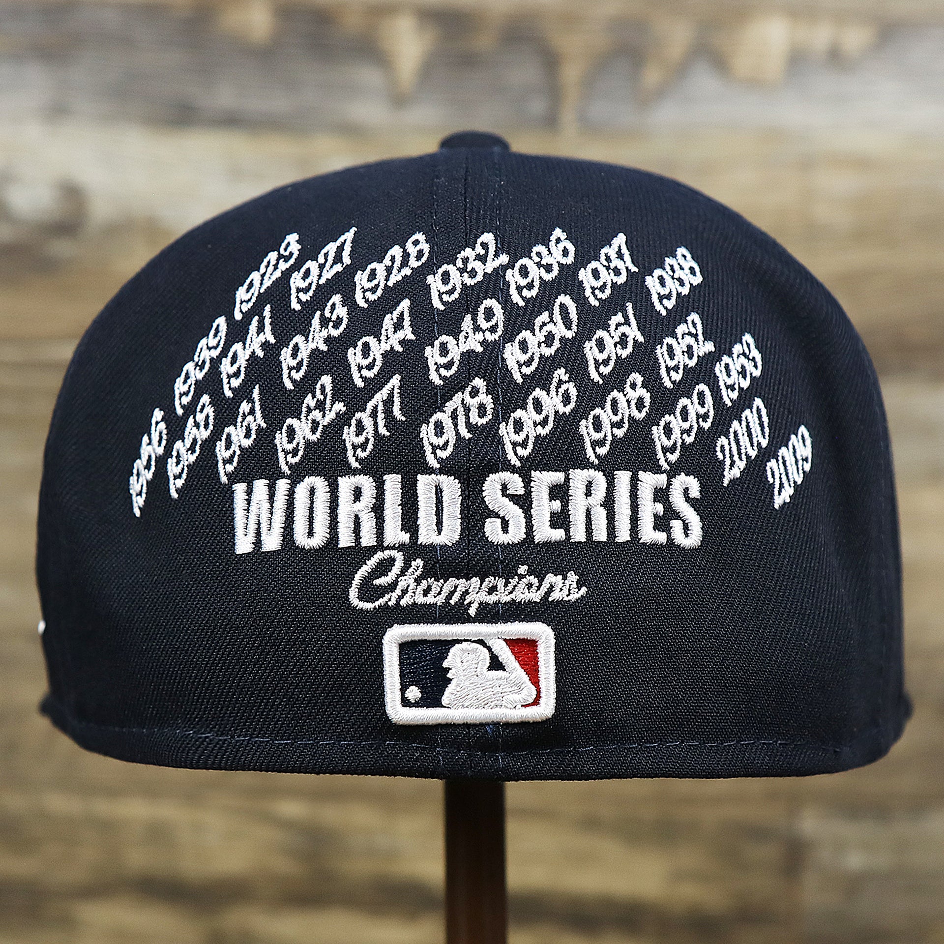 The backside of the New York Yankees Crown Champions Gray Bottom World Championship Wins Embroidered Fitted Cap | Navy Blue 59Fifty Cap