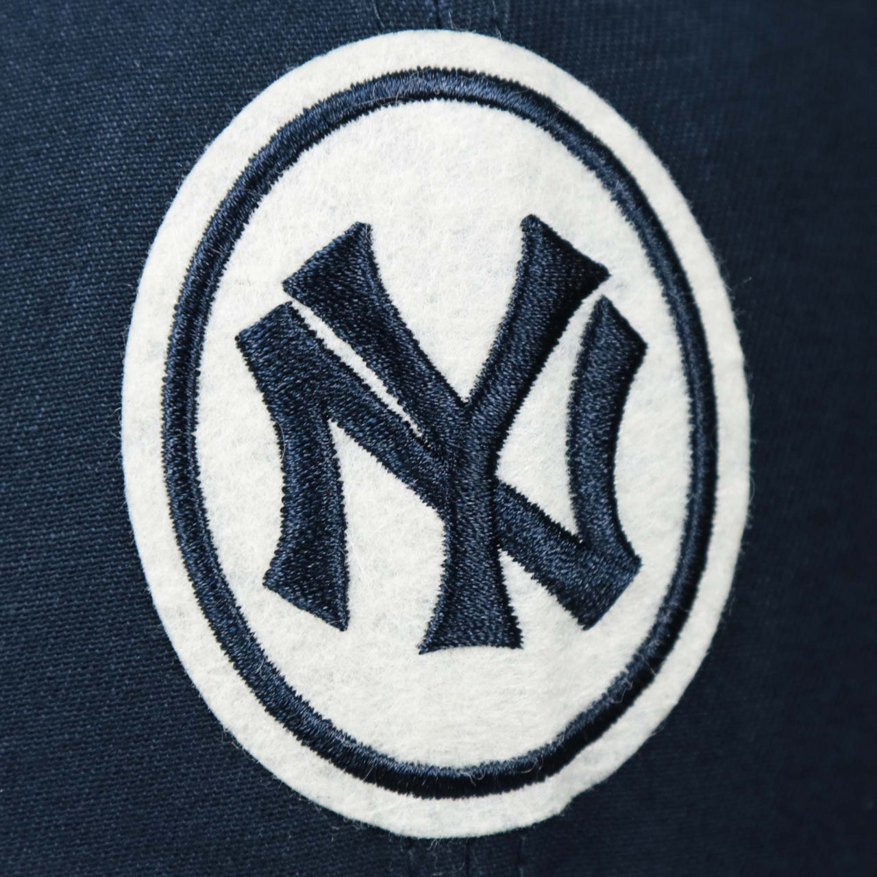 The felt logo on the Cooperstown New York Yankees Felt Yankees Logo Snapback Hat | Navy Snapback Cap