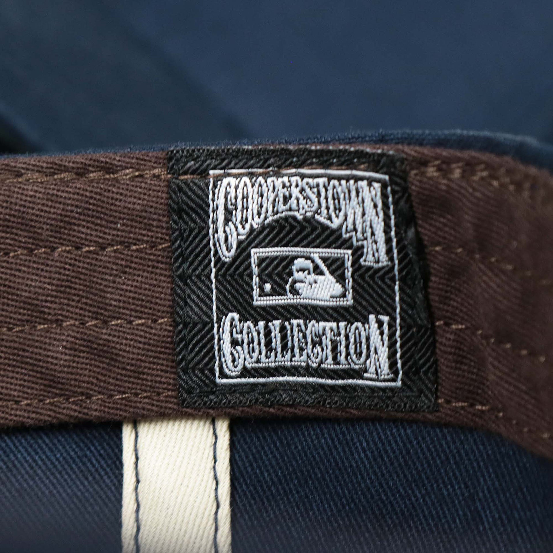 The Cooperstown Collection Logo on the Cooperstown New York Yankees Felt Yankees Logo Snapback Hat | Navy Snapback Cap