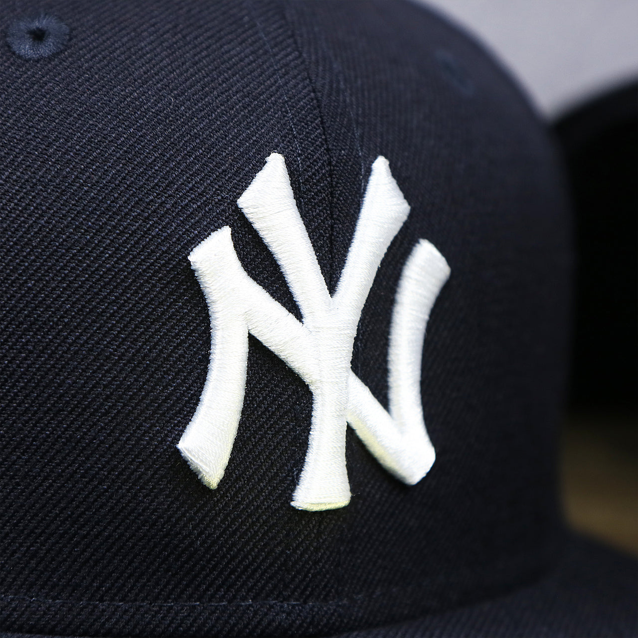 The Yankees Logo on the New York Yankees Gray Bottom Wool 59Fifty Fitted Cap | Navy Blue 59Fifty Cap