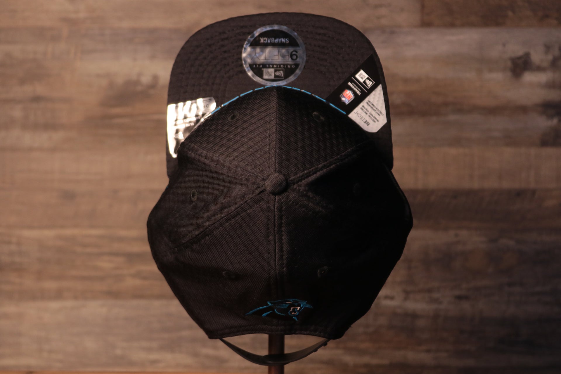 The top of this hat is a stretchy material for perfect fit Panthers 2020 Training Camp Snapback Hat | Carolina Panthers 2020 On-Field Black Training Camp Snap Cap