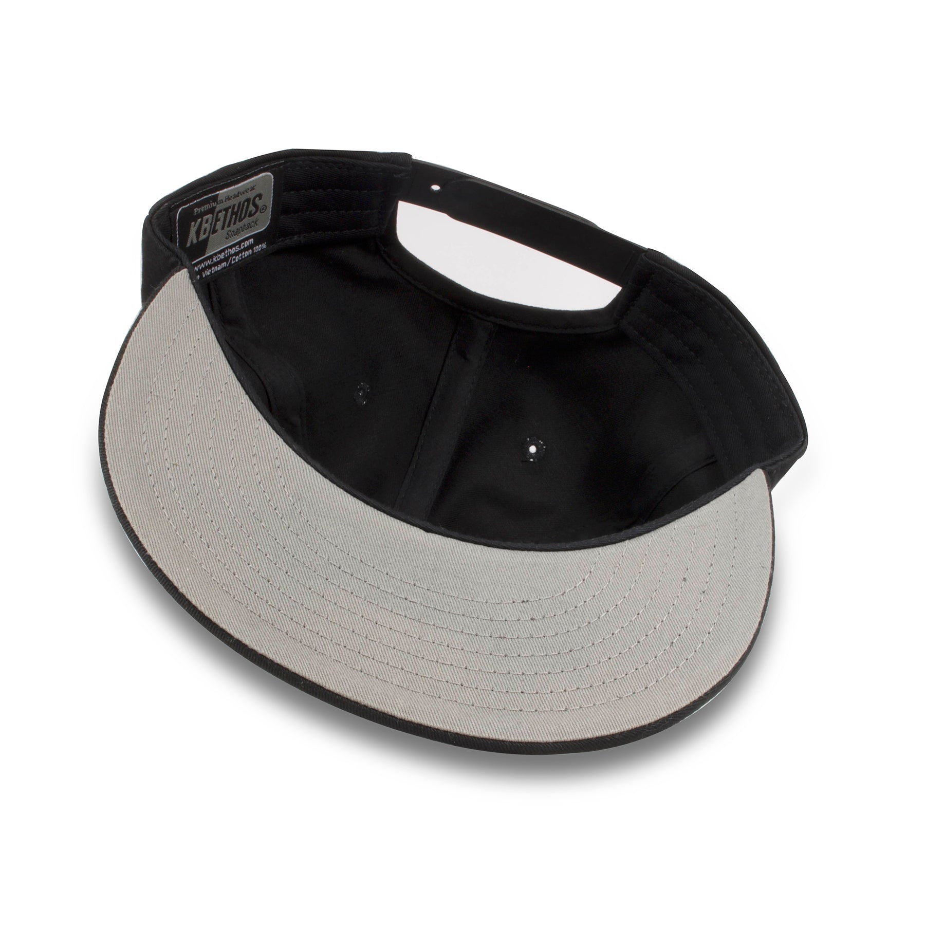 The under brim of the black adjustable blank snapback hat is gray