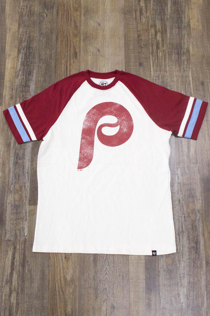 on the front of the Philadelphia Phillies Throwback Vintage 2-Tone T-Shirt | Distressed Phils Logo Cooperstown Collection Heritage Opener Tee is a worn maroon red Phils logo and pitcher stripe sleeves
