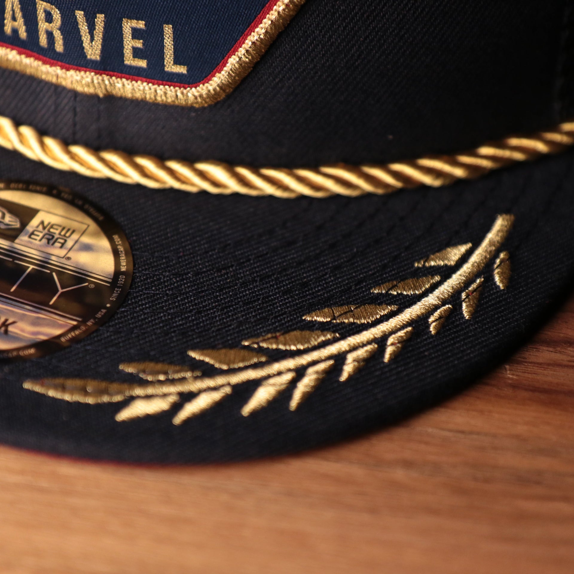 Captain Marvel Red Bottom Snapback | Captain Marvel Navy Trucker Red Bottom Snap Cap the brim of this cap is navy with gold designs on it
