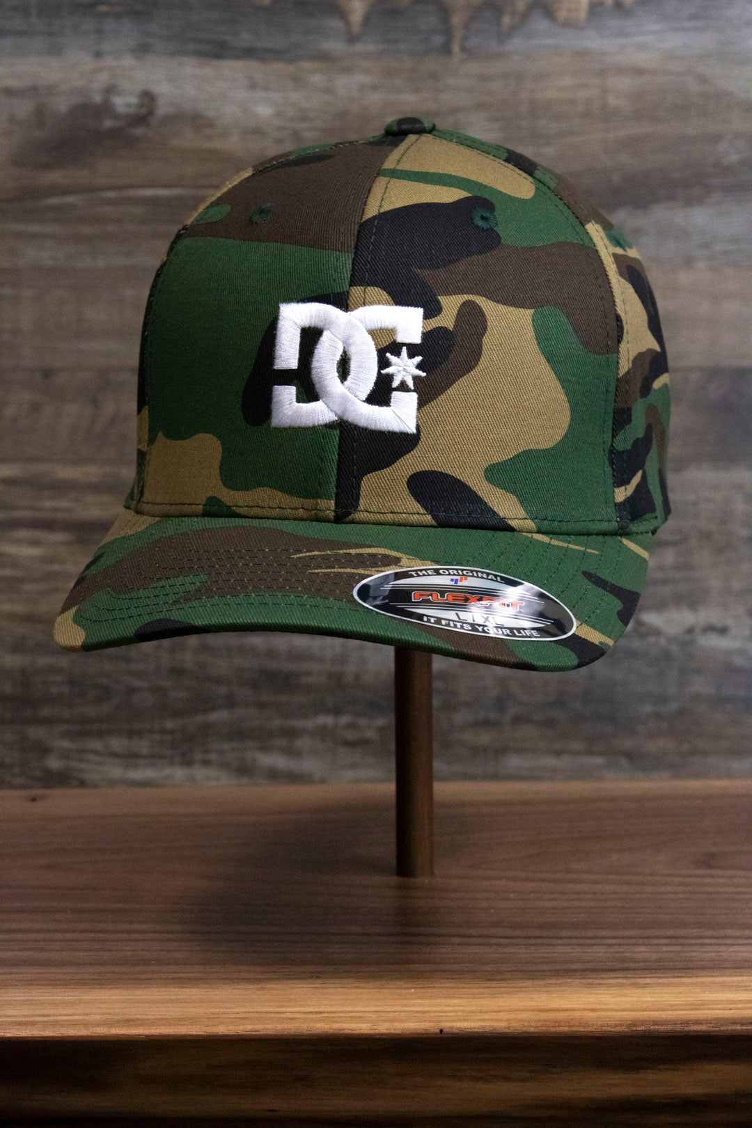 the Camouflage Print Skater Hat | DC Shoes Black Bottom Camo Flexfit Cap has a bent brim and a flex fit