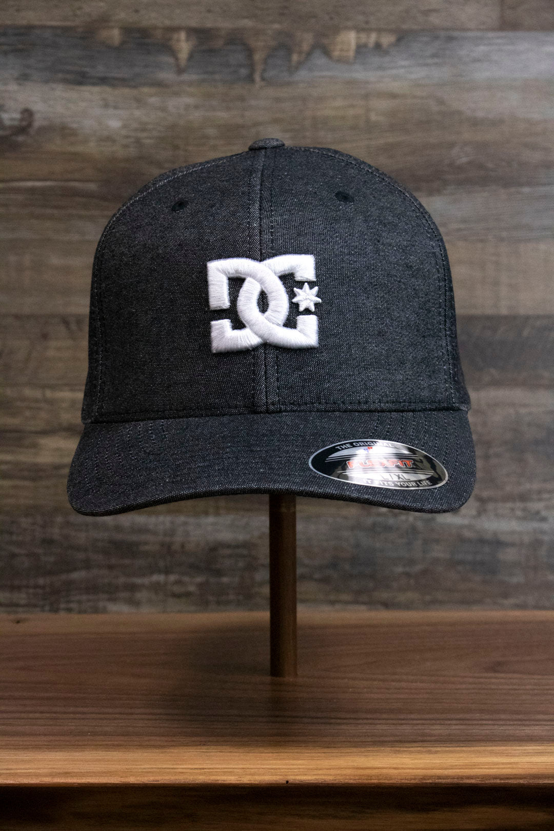 the Dark Gray Bentbrim Skater Hat | DC Shoes Black Bottom Heather Gray Flexfit Cap has a white puff logo on the front
