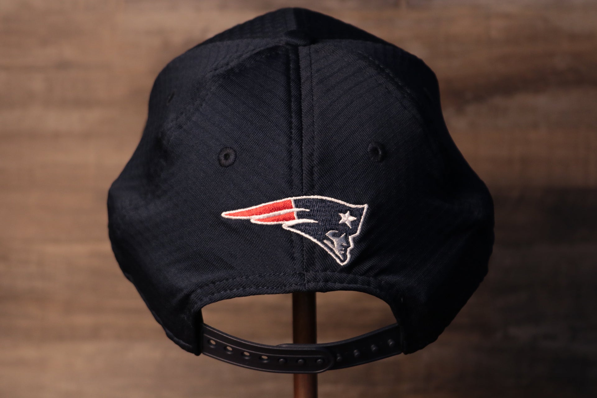 The back of this pats cap has their logo right above the snap Patriots 2020 Training Camp Snapback Hat | New England Patriots 2020 On-Field Navy Training Camp Snap Cap