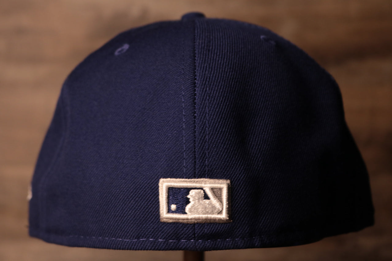 The back side has the MLB logo on it Dodgers Gray Bottom Fitted Cap | Los Angeles Dodgers Grey Bottom Royal Blue Fitted Hat