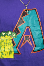 A close up of the logo on the Arizona Diamondbacks State Flower Cooperstown Shirt | New Era Purple