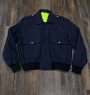 the Police Public Safety | Reversible Navy Blue Uniform Bomber Jacket | Waterproof Scotchlite Reflective Safety Green and Police Blue Rain Jacket has silver buttons and a neon yellow hi vis lining