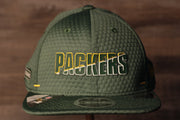 Packers 2020 Training Camp Snapback Hat | Green Bay Packers 2020 On-Field Green Training Camp Snap Cap the front of this packers hat has the packers name with a flat brim