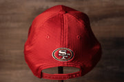 The backside has the 49ers logo above the snap 49ers 2020 Training Camp Snapback Hat | San Francisco 2020 On-Field Red Training Camp Snap Cap