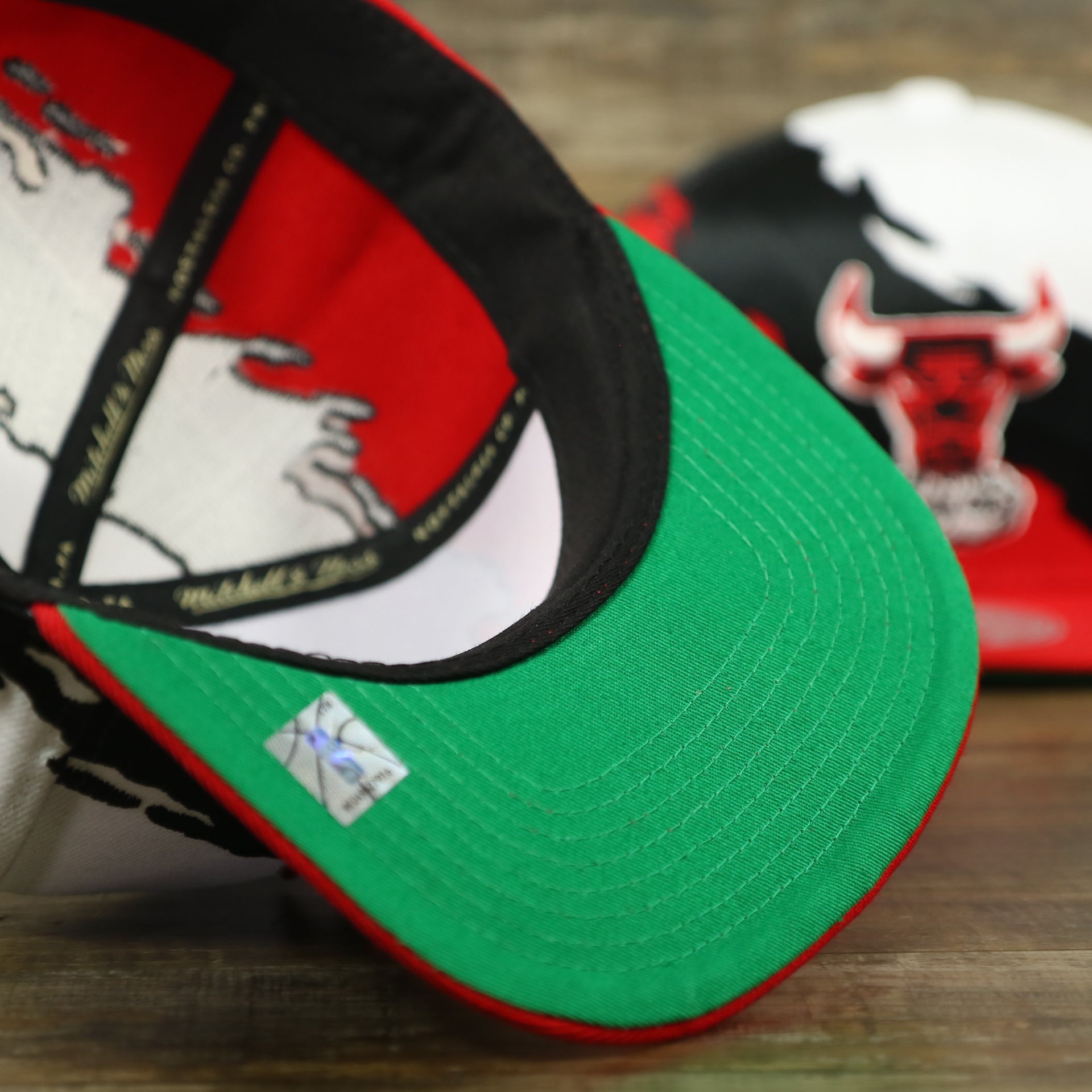 green under brim on the Chicago Bulls Vintage Retro NBA Paintbrush Mitchell and Ness Snapback Hat | Red/White/Black