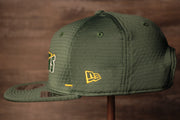 The wearers left side has the new era logo Packers 2020 Training Camp Snapback Hat | Green Bay Packers 2020 On-Field Green Training Camp Snap Cap