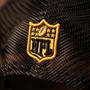 The back side of the grey/black Steelers 9fifty hat has the logo of the NFL.