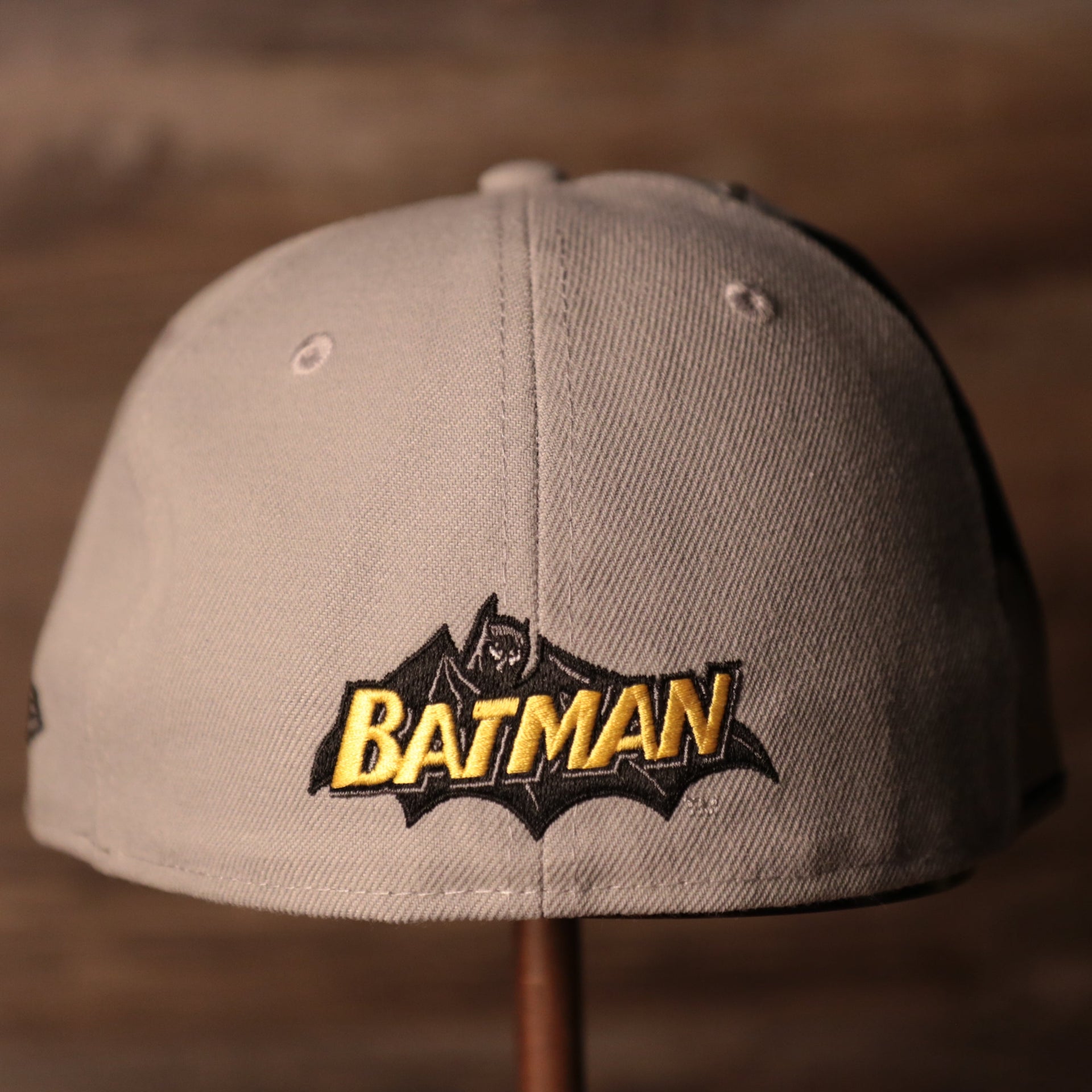 the back of this fitted cap has the batman name in yellow Batman Grey Bottom Fitted Cap | Batman Superhero Gray Bottom Fitted Hat