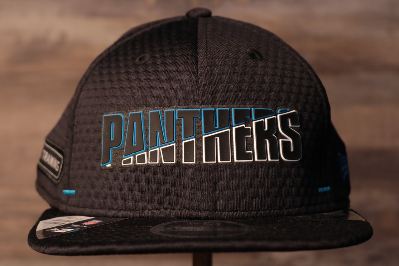 Panthers 2020 Training Camp Snapback Hat | Carolina Panthers 2020 On-Field Black Training Camp Snap Cap the front of this panthers training camp snapback has the panthers name on the front