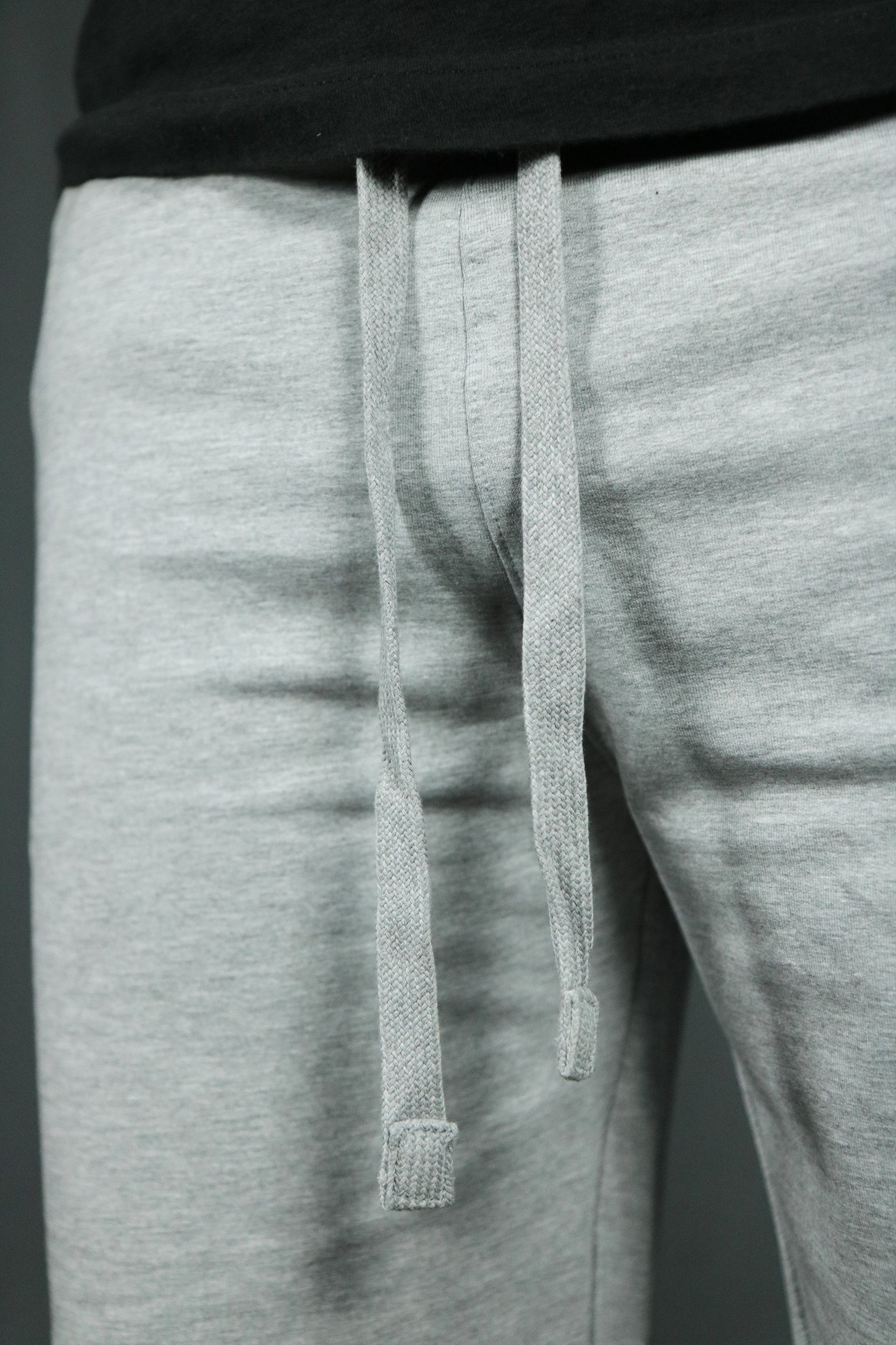 The drawstrings of the heather gray mens terry shorts.