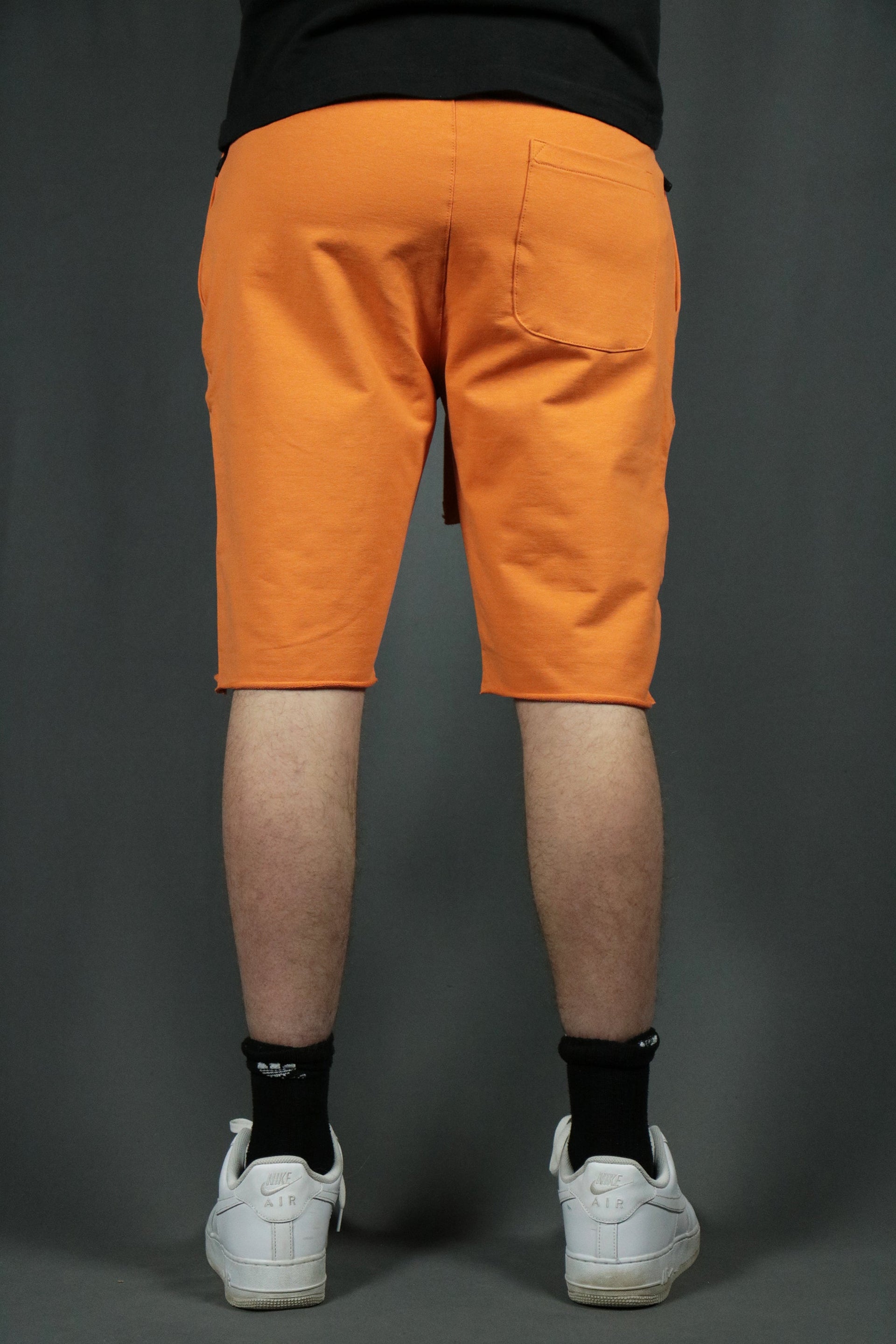 The orange Jordan Craig mens terry cloth shorts have one pocket at the back.