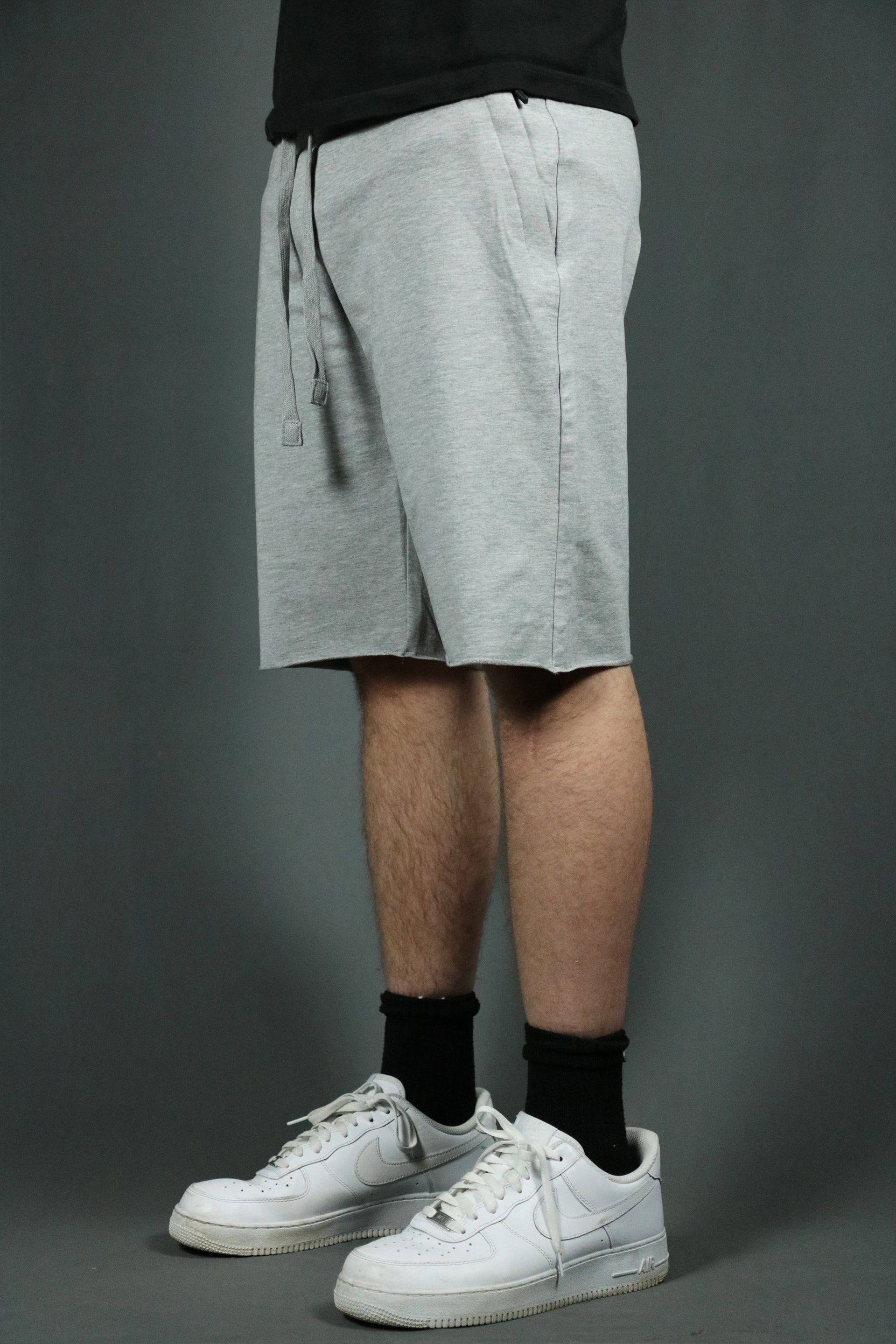 Model wearing the heather grey men's french terry shorts by Jordan Craig.