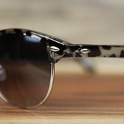 The hinge on the Round Frame Black Gradient Lens Sunglasses with Black Tortoise Silver Frame