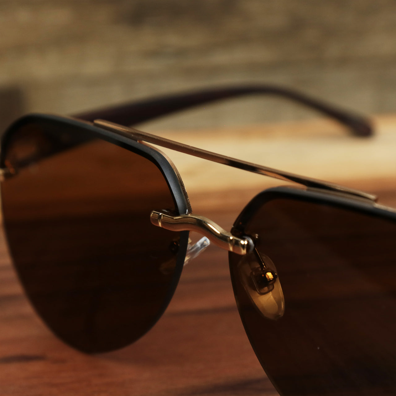 The bridge on the Round Aviator Frames Brown Lens Sunglasses with Gold Frame